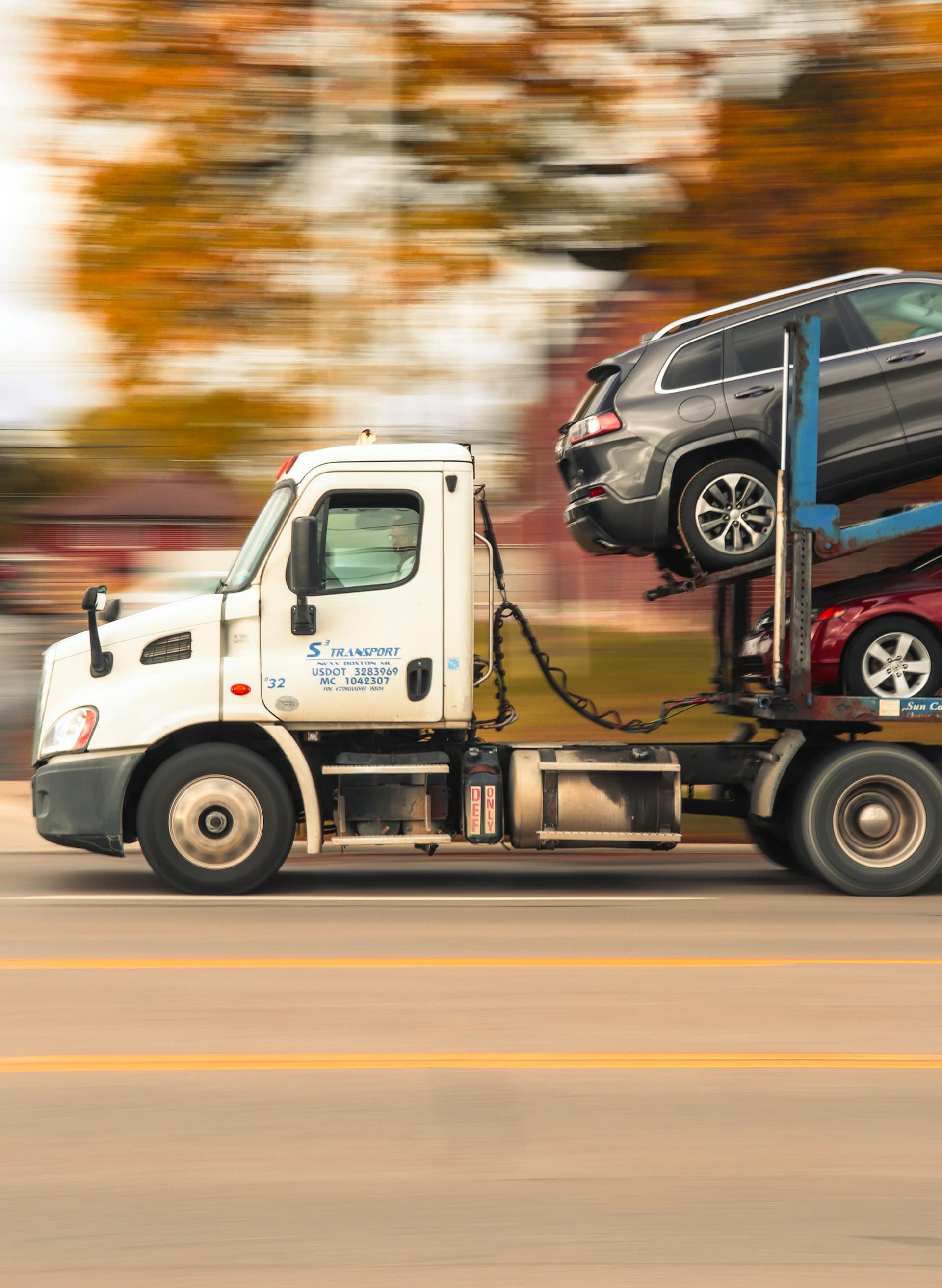 American car carrier truck transporting vehicles across the USA